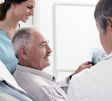 Smiling older man in dental chair