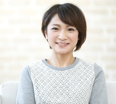 person smiling and sitting on a couch