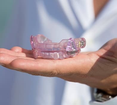 Hand holding a custom nightguard