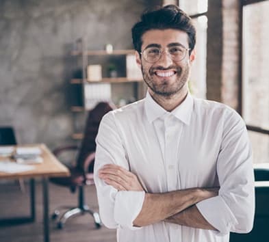 person smiling and crossing their arms