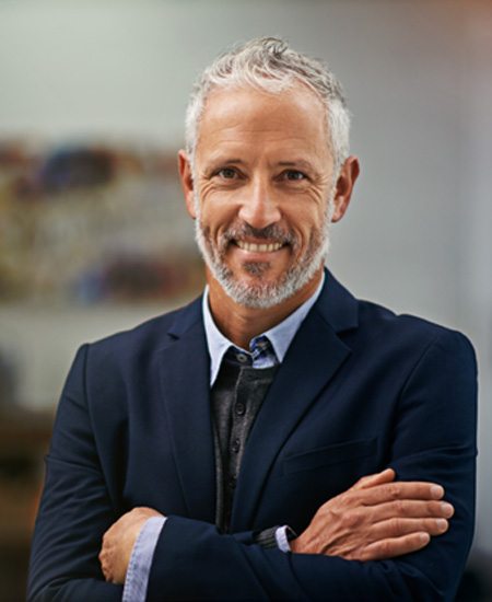 Middle-aged man smiling after seeing a Delta Dental Premier dentist in Alexandria 
