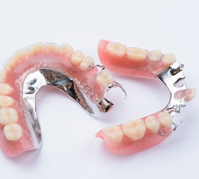 Two sets of partial dentures on white background