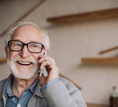 Man enjoying a smooth phone conversation with dentures