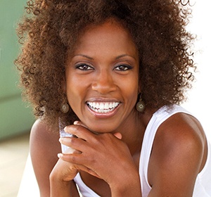 A woman with dental implants in Alexandria smiling.