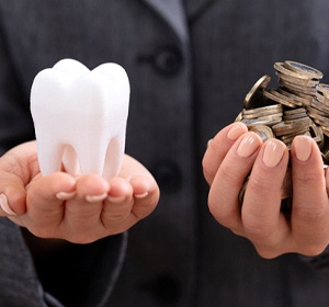 Hands holding molar and coins