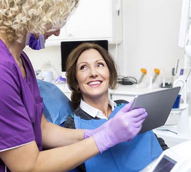 dentist showing a tablet to a patient