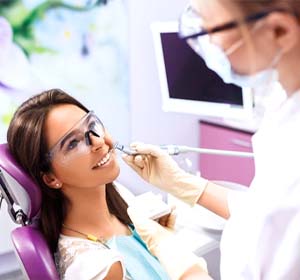 dentist treating patient with soft tissue laser