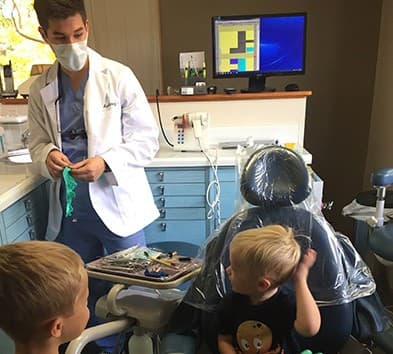 Dr. Martinez talking to child in dental chair