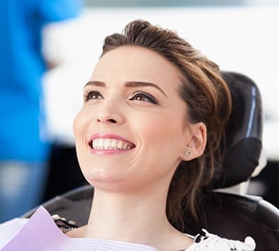 Woman in dental chair smiling