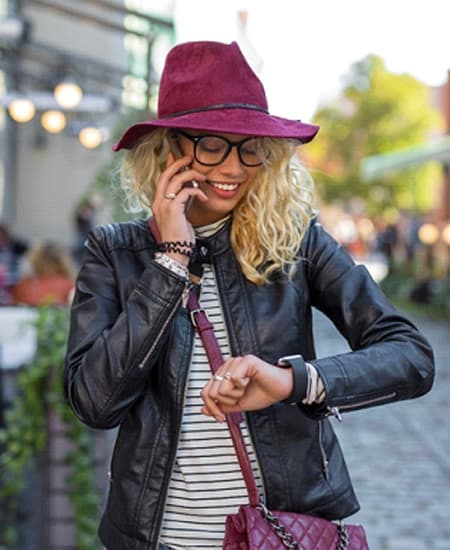 person walking in the city checking their watch