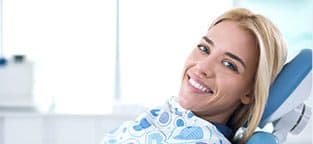 Woman in dental chair smiling