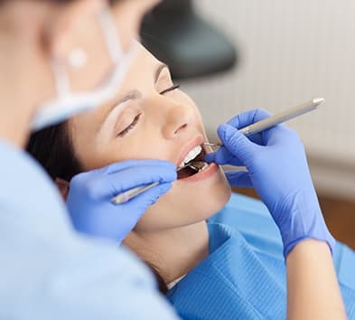 Relaxed woman receiving dental exam