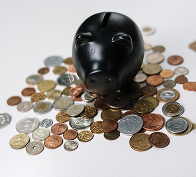 Black piggy bank on coins