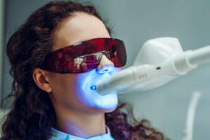 Woman having in-office teeth whitening treatment
