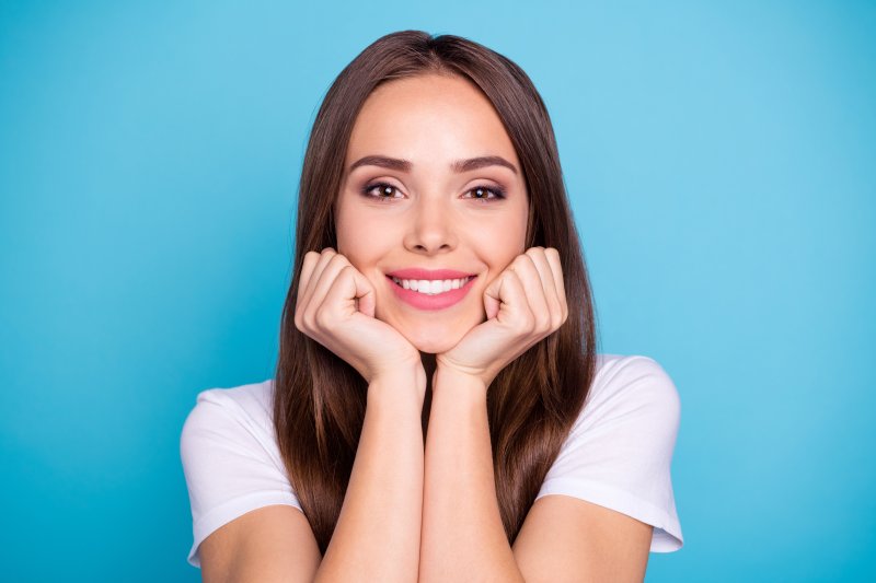 A woman smiling after her cosmetic dentistry treatments