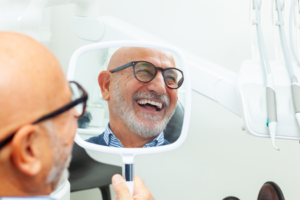 a patient admiring his cosmetic dental results